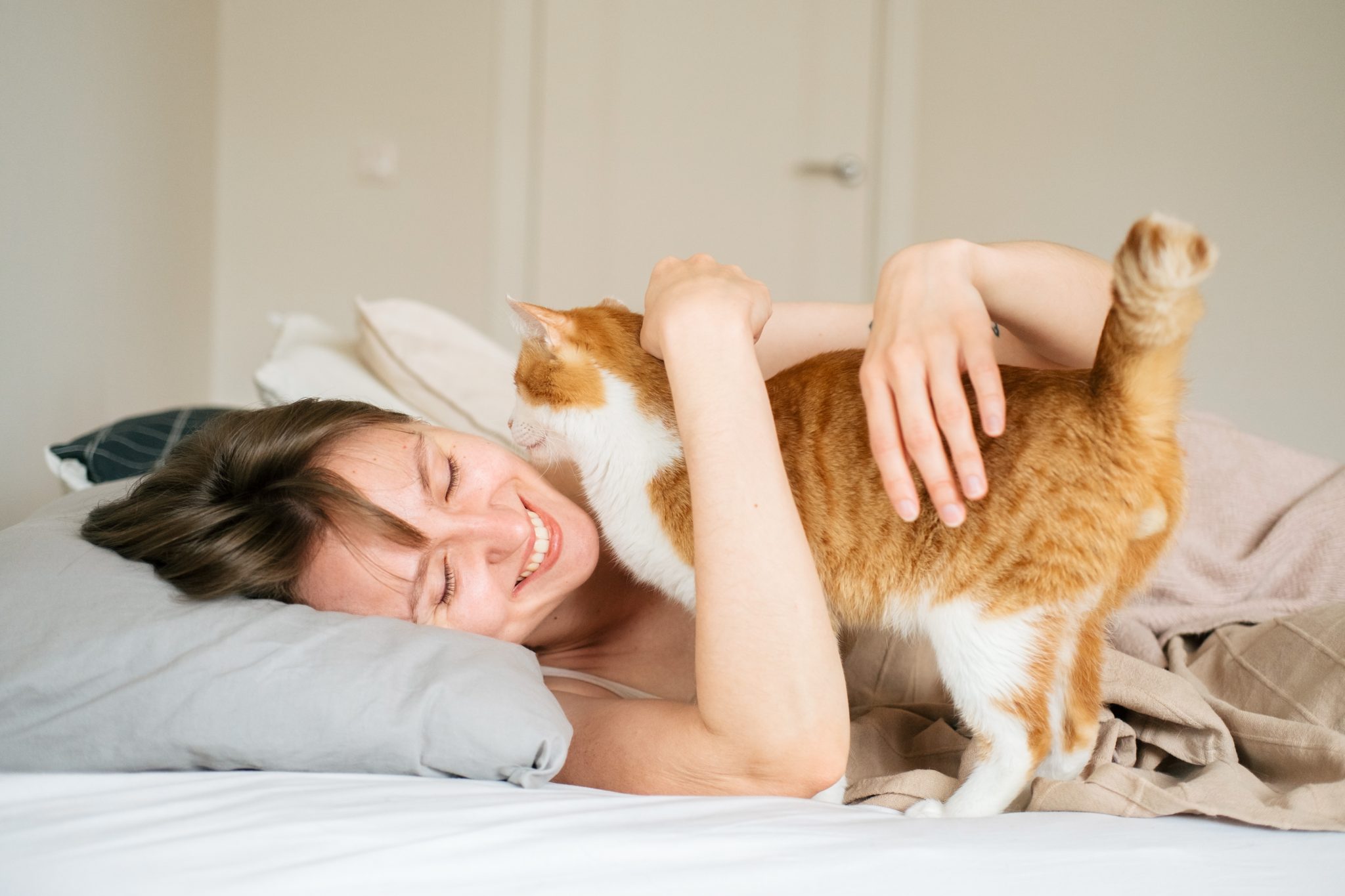 Woman hugging her cat at the morning